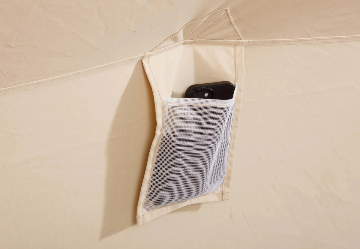 CanvasCamp Apex 4 x 6 intérieur, poche de rangement en filet sur la paroi avec un téléphone dedans